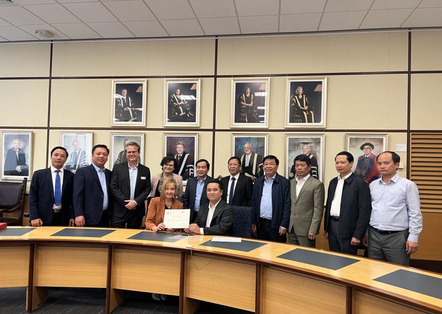 Elite Global Invest and partner delegates at a signing in a university boardroom